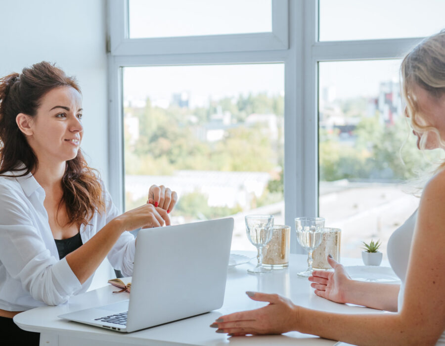 Beautiful female coach is consulting young woman Female coach is consulting young woman indoor.