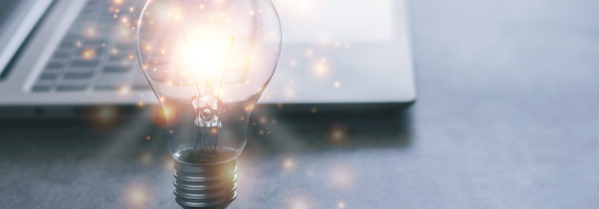 Laptop and glowing light bulb. Self learning or education knowledge and business studying concept. Idea of learning online or e-learning from home.